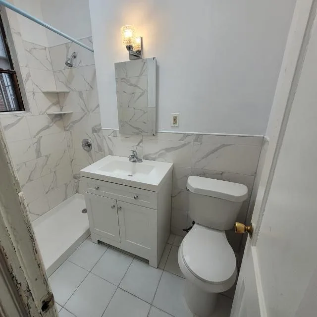 Fully remodeled bathroom with new vanity, toilet, and tub-shower combo