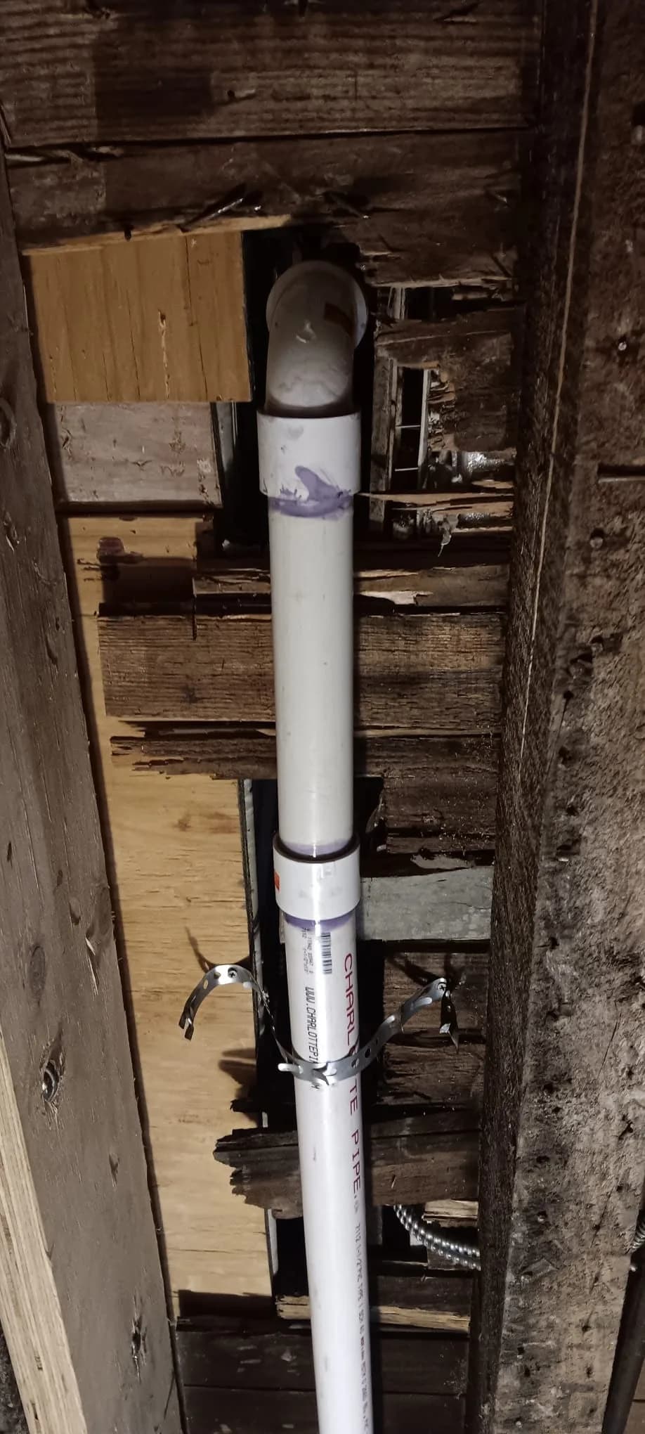 New PVC waste pipe installed inside an open wall cavity