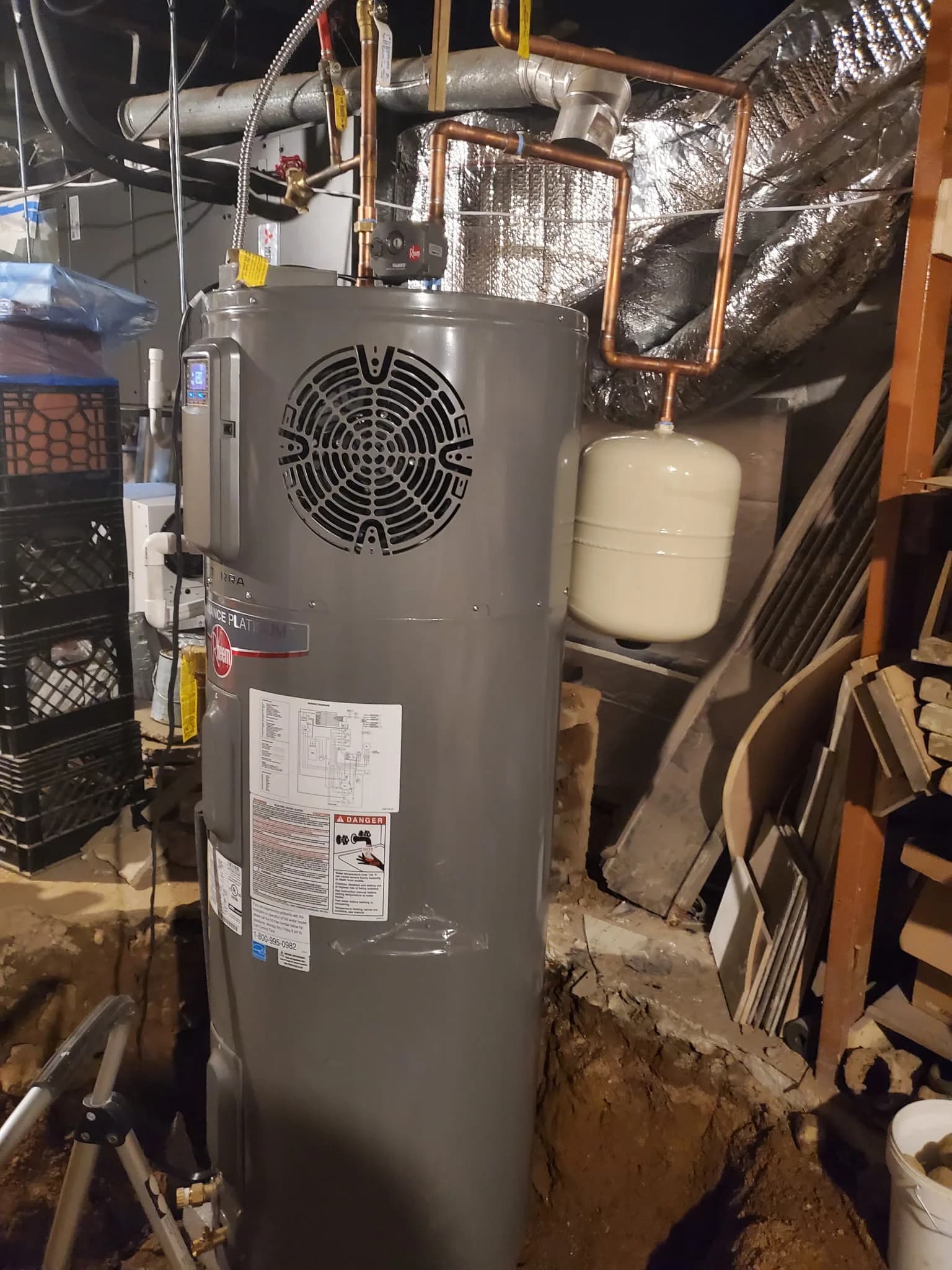 New water heater installation with copper piping in a residential basement