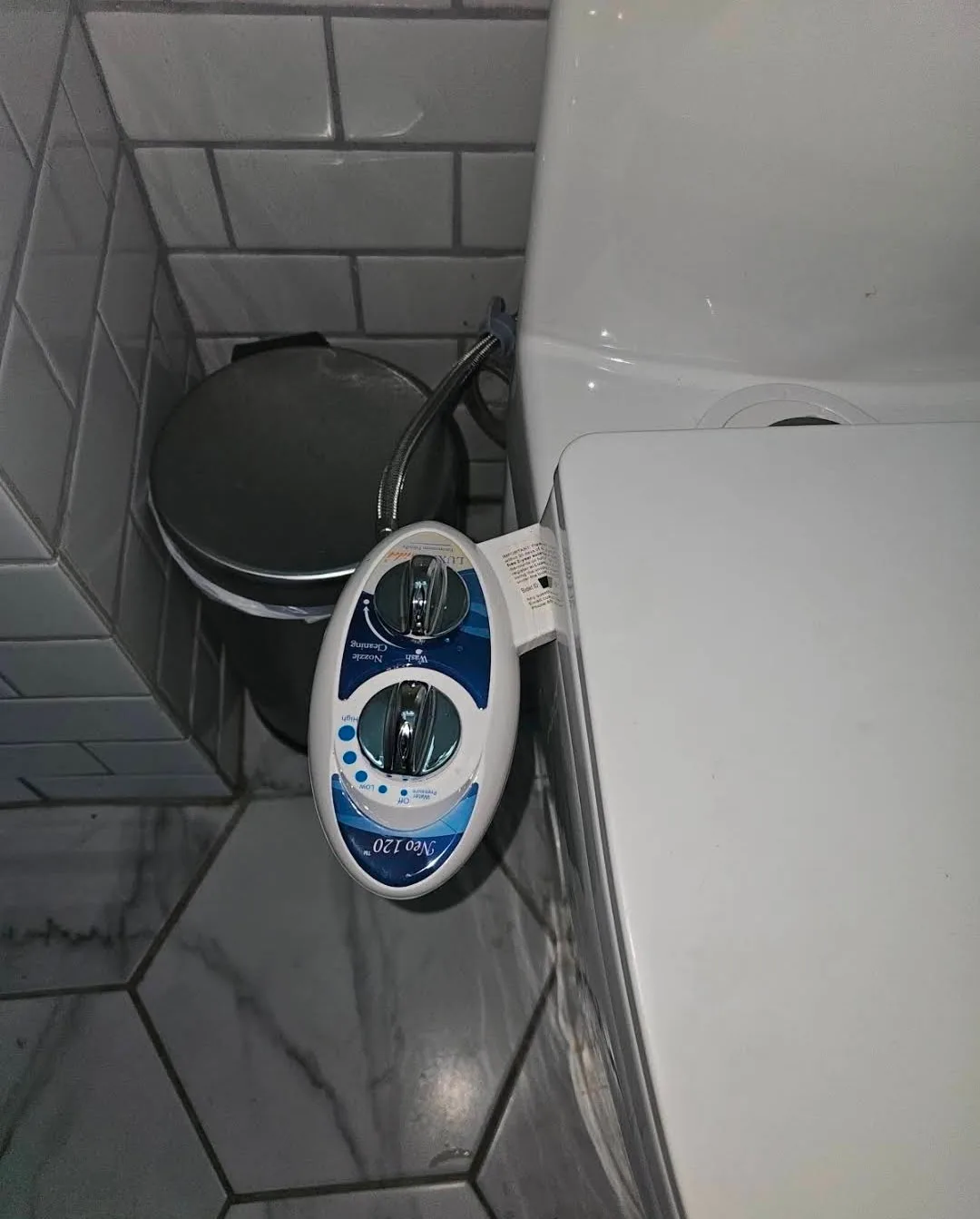 Bidet attachment installed and connected beside the toilet